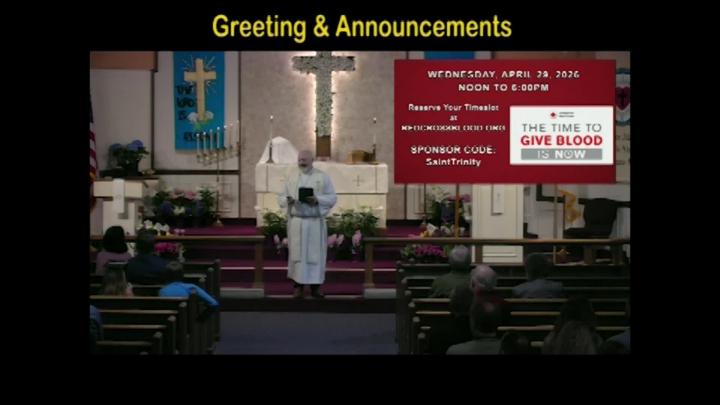 A pastor standing center frame with the text Greetings and Announcements above written in yellow. 