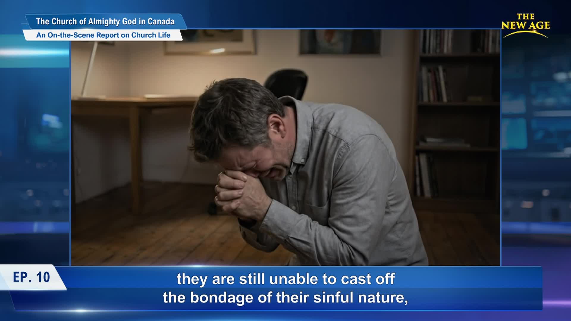 A man, center frame, praying with a blue box acting as a background. 