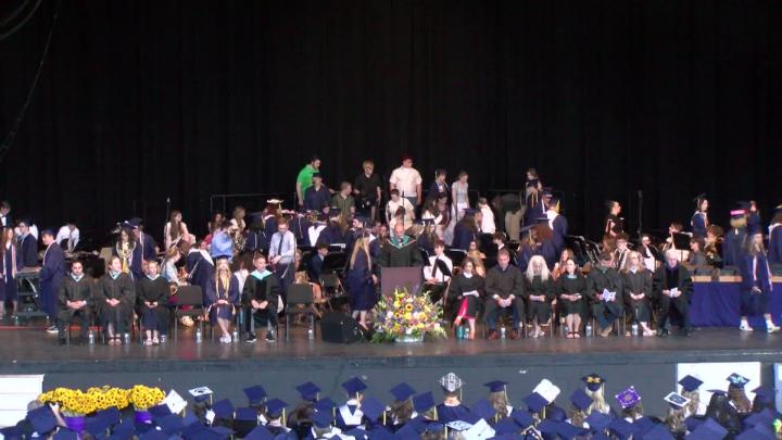 A group of administrators for Clarkston High School line the stage at Pine knob Music Theater for the 2026 Commencement Ceremony 
